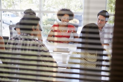 designers-having-meeting-viewed-through-window